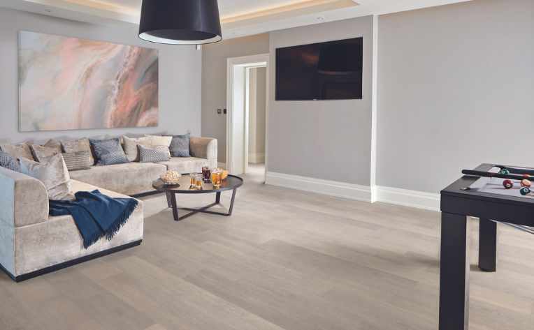 light washed wood look luxury vinyl in basement entertainment space
